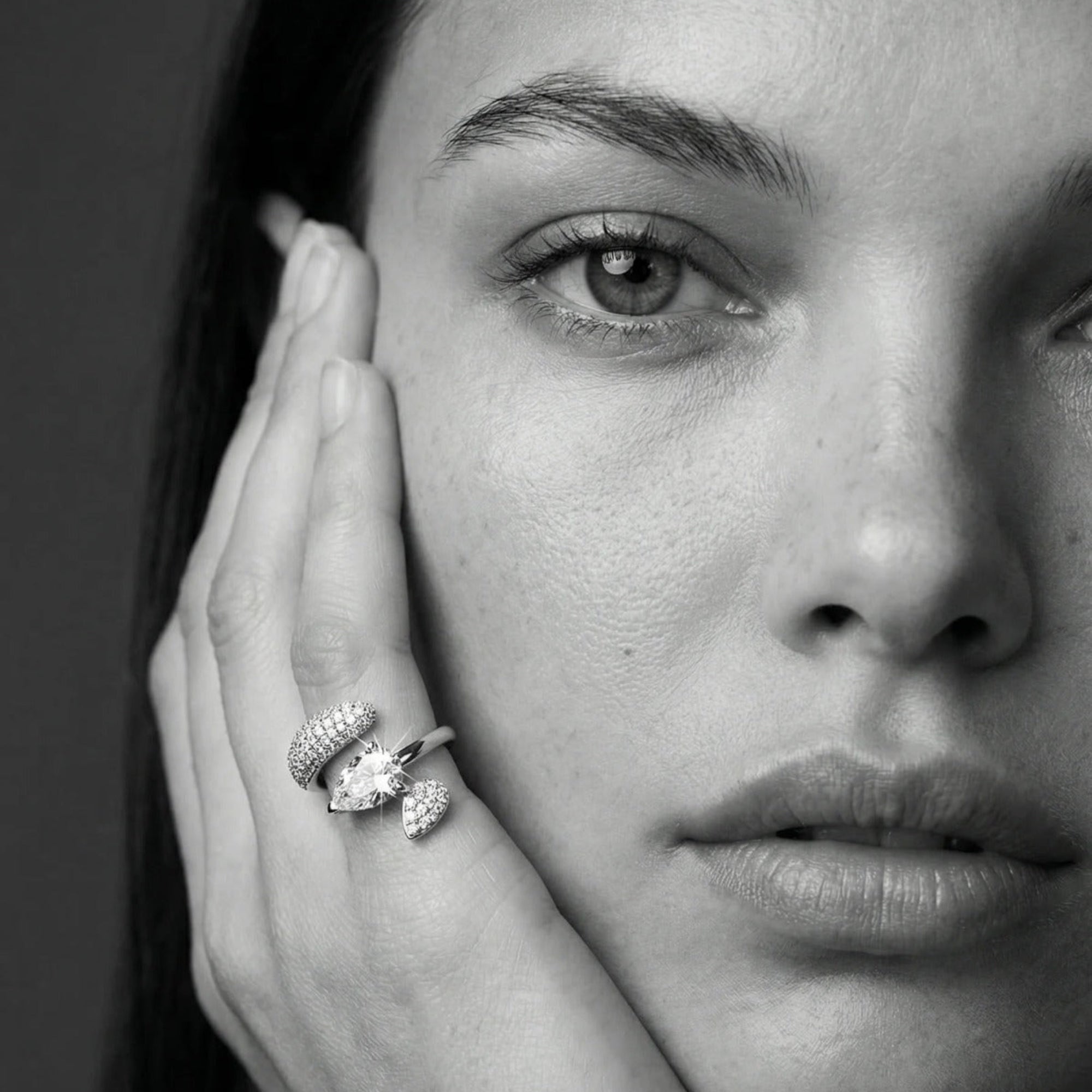 Woman wearing a Ring in 14K gold with a pear white sapphire and pavé white diamonds